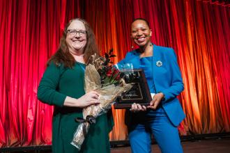 Fordham HS for the Arts teacher Linda Key (left) receives the Stanley Schair CTE Teacher of the Year Award from a presenter with Google at the 2025 UFT Career and Technical Education Awards at the Sheraton New York Times Square Hotel on Feb. 26, 2025.