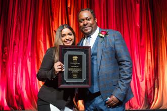 Karina Budhu, a fourth-year SVA apprentice, receives the Edwin Espaillat Award from Gordon at the 2025 UFT Career and Technical Education Awards at the Sheraton New York Times Square Hotel on Feb. 26, 2025.
