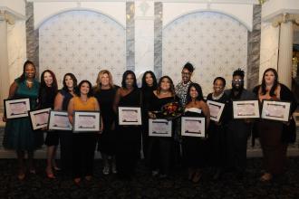 Award-winning UFT members beam as they show off their plaques at the UFT District 11 Scholarship Dinner on March 28, 2025. 