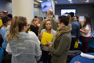 Ladies talking to each other in a crowded room