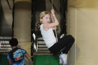 An 8-year-old rides the zip line at UFT Family Day on March 29, 2025. 