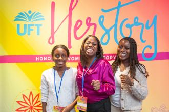 A woman takes a photo with her daughters at the UFT HERstory brunch on March 15, 2025. 