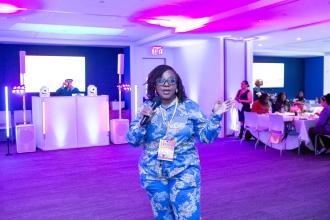 UFT Vice President Janella Hinds, the event organizer, welcomes the attendees to the 2025 UFT HERstory brunch. 
