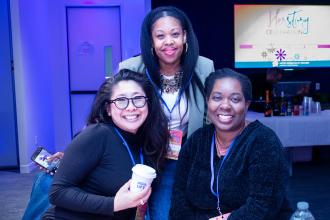 Three women take a group photo at the UFT HERstory brunch on March 15, 2025.