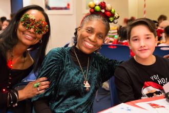 Smiling women wearing Christmas-themed glasses