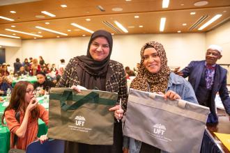 Members beam after winning UFT tote bags at the UFT's annual Iftar celebration on Feb. 27, 2026. 