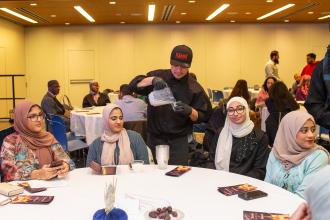 Guests are provided cups of milk, a drink that is traditionally served to break the Ramadan fast, along with water and dates at the UFT Muslim Educators Committee Iftar Dinner on March 7, 2025. 