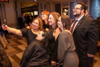 A group of attendees at the 2024 UFT Jewish Heritage Tikkun Olam Awards Dinner gather for a selife on the dance floor. 