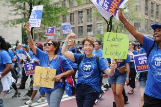 Lisette Morales Lugo (center), a bilingual school psychologist at Fannie Lou Hamer Freedom HS in the Bronx, marches alongside fellow UFT members up Fifth Avenue during the Labor Parade.