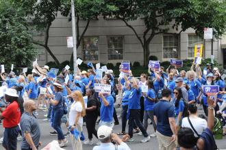 Members march pass the reviewing stand on Fifth Avenue during the Labor Parade.