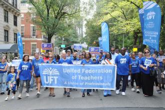 The UFT banner is carried high as the union contingent advances along Fifth Avenue during the 2025 NYC Labor Parade