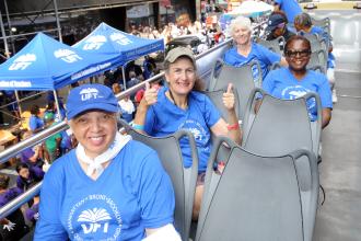 Members of the Retired Teachers Chapter show their union pride from atop the double-decker union parade bus during the 2025 NYC Labor Parade.