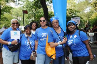 UFT paraprofessionals take a group photo during the 2025 NYC Labor Parade. 