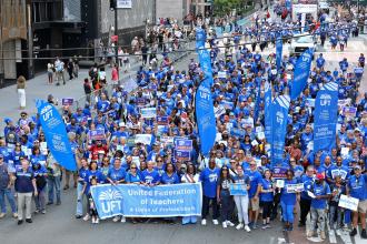 UFT members create a sea of union blue as they amass for the Labor Parade.