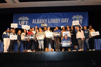 District 32 members get onstage at the Convention Center for a group photo after lunch at Lobby Day on March 10, 2025.