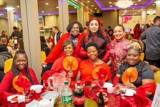 A group of attendees at the 2025 UFT Asian Heritage Committee Lunar New Year Banquet pose for a group photo.