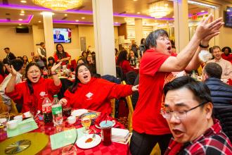A woman reaches to catch lettuce thrown into the crowd at the UFT Asian Heritage Committee Lunar New Year Banquet on Feb. 28, 2025. 