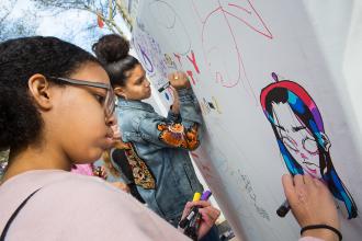 Kids drawing with markers on paper