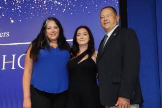 Teachers smile on stage after receiving their awards at the inaugural UFT Middle School Awards on May 15, 2025. 