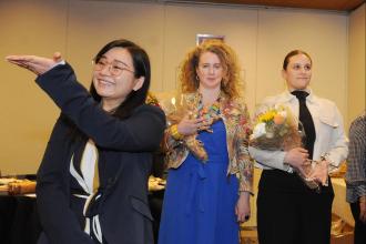 Teacher Jiehua Xuan acknowledges her supporters from IS 220 in Sunset Park, Brooklyn, as she stands to accept her School Culture Award.