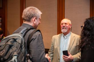 Retired Teachers Chapter Leader Bennett Fischer greets the retirees before the UFT New Retiree Luncheon at the Midtown Hilton on Dec. 5, 2024. 