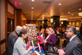 New retirees get information from Si Beagle coordinators at the UFT New Retiree Luncheon on Dec. 5, 2024. 