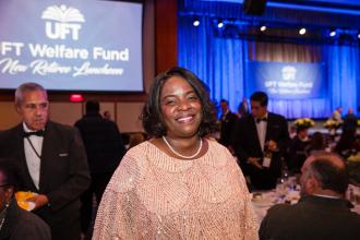 A woman smiles for a photo at the UFT New Retiree Luncheon on Dec. 5, 2024 at the Midtown Hilton.