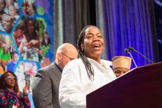 Marsha Malone-Culcleasure, a paraprofessional at PS 36 in Brooklyn, accepts one of two Humanitarian Awards bestowed during the UFT Paraprofessionals Awards Luncheon on March 22, 2025. 