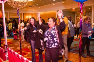 Debra Elhadri, the chapter leader at PS 75 in Brooklyn, cheers after winning a game at the festival at the 2025 UFT Paraprofessional Awards Luncheon on March 22. 