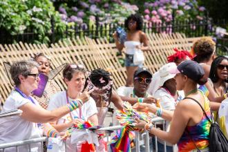 UFT members interact with the crowd at the 2025 NYC Pride March. 