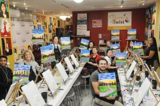 Members show off their finished works of art during a painting event in Queens on March 27.