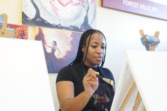 A new UFT member works on a painting during a new member event on March 27. 