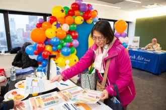 Tiffany Pong, the parent  of a LaGuardia HS student, peruses tables at the resource fair.