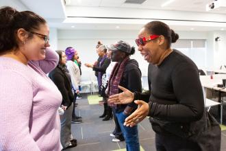 Parents Andrea Daniels (left) and Donna Bailey-Copeland work through emotions during a grief exercise in a workshop titled, “Through the Storm.”