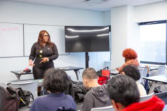 Tanisha Marie Adjokatcher, a financial coach, leads attendees in a personal finances workshop titled “Money Moves.”