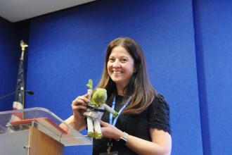 Keynote speaker school psychologist Rebecca Branstetter prepares a visual aid for her speech on using AI tools to make paperwork tasks more efficient at the 2025 UFT School Counselors Conference