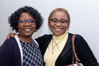 Two school nurses meet for a photo at the 2025 UFT School Nurse Appreciation Dinner on May 7 at UFT headquarters. 