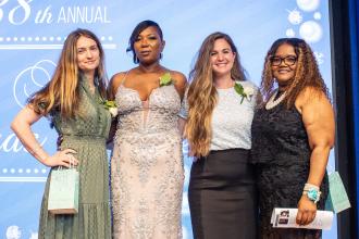 Staten Island honorees take a photo on stage at the UFT School Secretary Awards Soiree on June 6, 2025. 