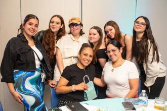 School secretary Lucrecia Ochs (bottom left), an honoree from PS 201 in Queens, is surrounded by her family at the UFT School Secretary Awards Soiree on June 6, 2025. 
