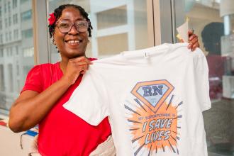 School nurse Patricia Theodore of PS 46 in Brooklyn’s T-shirt bursts with union pride: "My superpower is I save lives."