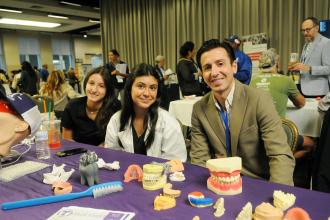 Tottenville High School students and their teacher take a photo at their exhibit hall table during the 2025 UFT Spring Education Conference. 