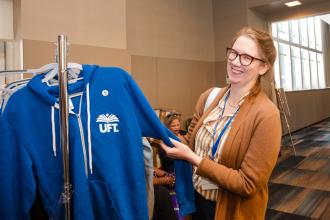Emily Christensen, a teacher at MS 51 in Brooklyn and a UFT Teacher Center coach, browses UFT merchandise during the UFT Spring Education Conference. 