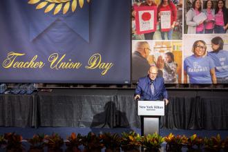 Mulgrew opens Teacher Union Day by praising members for their work in accomplishing recent victories like the statewide, bell-to-bell cellphone ban and the push for smaller class sizes, and speaks of the ongoing battles ahead, including the paraprofessional “RESPECT check” and Fix Tier 6 campaigns.