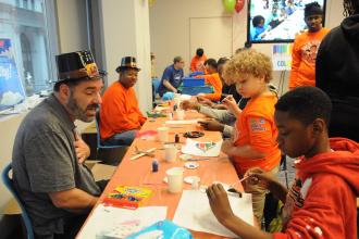Michael Martin, a 3-K teacher at PS 157 in the Bronx, volunteers to lead a model-airplane-painting activity.