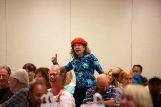 A retiree in attendance makes guests laugh during the 30th annual UFTWF Day at the University. 