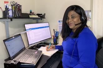 Nurse sitting at desk in front of computer