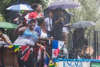 People holding umbrellas on UFT float