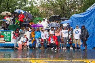 Large group of UFT members in front of UFT float
