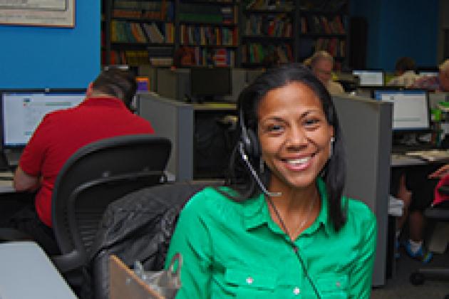 Smiling woman with a phone head set