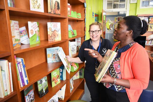 Two women looking at shelf of books